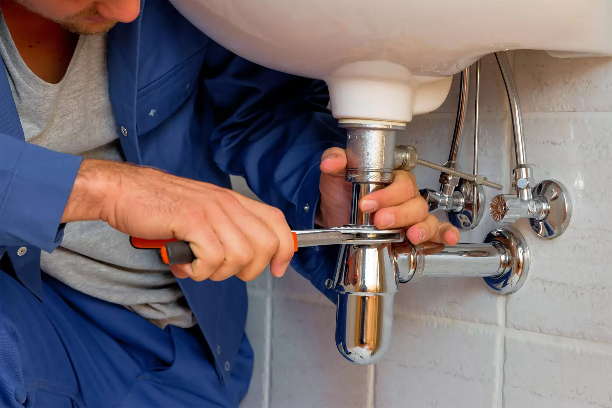 plumber fixing sink